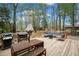 Large back deck featuring a dining area and comfortable outdoor seating, ideal for entertaining at 6695 Woodstock Rd, Acworth, GA 30102