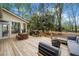 Spacious back deck with outdoor seating, a grill, and access to the screened porch at 6695 Woodstock Rd, Acworth, GA 30102