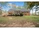 Charming brick home with a spacious backyard, wooden deck, and a sunroom at 6695 Woodstock Rd, Acworth, GA 30102