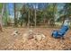 Picturesque backyard with a fire pit and seating, surrounded by trees at 6695 Woodstock Rd, Acworth, GA 30102