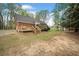 Brick home with a spacious backyard and wooden deck at 6695 Woodstock Rd, Acworth, GA 30102