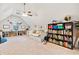 Large bonus room featuring study space, daybed, bookshelves and neutral carpet at 6695 Woodstock Rd, Acworth, GA 30102