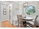 Charming breakfast nook featuring a corner table, wainscoting, and a unique octagon window with backyard view at 6695 Woodstock Rd, Acworth, GA 30102
