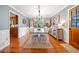 Dining room with hardwood floors, wainscotting, and elegant lighting fixture at 6695 Woodstock Rd, Acworth, GA 30102