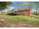 Brick home exterior with a sunroom, back deck and manicured lawn at 6695 Woodstock Rd, Acworth, GA 30102