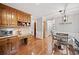 Classic kitchen featuring wooden cabinets, hardwood floors, a built-in desk, and a charming breakfast area at 6695 Woodstock Rd, Acworth, GA 30102