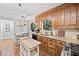 Functional kitchen equipped with wooden cabinets, granite countertops, and a cozy breakfast nook with an octagon window at 6695 Woodstock Rd, Acworth, GA 30102