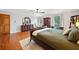 Main bedroom with wood floors, dresser, and view to outdoors at 6695 Woodstock Rd, Acworth, GA 30102
