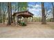 Wooden shed and tractor in a wooded backyard at 6695 Woodstock Rd, Acworth, GA 30102
