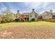 Expansive backyard with mature trees, deck, and ample space for recreation, offering a serene outdoor environment at 2323 Council Ln, Buford, GA 30519