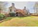 Spacious backyard featuring a deck, lush lawn, and mature trees, perfect for outdoor gatherings and relaxation at 2323 Council Ln, Buford, GA 30519
