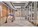 Unfinished basement with exposed ceiling and concrete floor, framed for customization and ample storage space at 2323 Council Ln, Buford, GA 30519