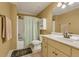 Well-lit bathroom featuring tiled floors, a single vanity, and a tub-shower combination at 2323 Council Ln, Buford, GA 30519