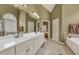 Spacious primary bathroom features double vanity sinks, soaking tub, and a large arched window at 2323 Council Ln, Buford, GA 30519