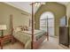 Well-lit bedroom with a four-poster bed, complemented by a large window at 2323 Council Ln, Buford, GA 30519