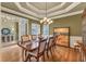Formal dining room featuring a large wood table, decorative lighting and trey ceiling at 2323 Council Ln, Buford, GA 30519