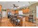Spacious kitchen features a large island with seating, stainless steel appliances, and beautiful wood cabinetry at 2323 Council Ln, Buford, GA 30519