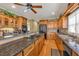 Open kitchen with granite counters, wood cabinets, stainless appliances, and large island at 2323 Council Ln, Buford, GA 30519