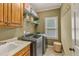 Laundry room equipped with washer, dryer, sink, and shelving for optimum convenience at 2323 Council Ln, Buford, GA 30519