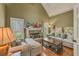 Cozy living room with fireplace and large windows offering scenic views of the outdoors at 2323 Council Ln, Buford, GA 30519