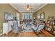 Cozy living room with hardwood floors, leather sofas, ceiling fan, and decorative furnishings at 2323 Council Ln, Buford, GA 30519
