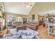 Open concept living room and kitchen featuring fireplace, leather sofas, and natural light at 2323 Council Ln, Buford, GA 30519