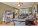Comfortable living room with hardwood floors, leather sofas, ceiling fan, and decorative furnishings at 2323 Council Ln, Buford, GA 30519