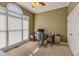 Comfortable home office with a large arched window, a ceiling fan, and neutral carpeting at 2323 Council Ln, Buford, GA 30519