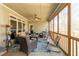 Inviting screened-in patio features comfortable seating and a ceiling fan, perfect for relaxing outdoors at 2323 Council Ln, Buford, GA 30519