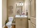 Cozy powder room with elegant fixtures, decorative mirror and sconces at 2323 Council Ln, Buford, GA 30519