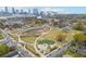 Aerial view showcases a vibrant urban park with playgrounds, green spaces, walking paths, and surrounding neighborhood at 510 James P. Brawley Dr. Nw Dr, Atlanta, GA 30318