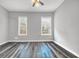 This bedroom features wood flooring, neutral paint, and two windows at 510 James P. Brawley Dr. Nw Dr, Atlanta, GA 30318