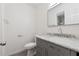 Bathroom features a gray vanity with marble countertop and updated fixtures at 554 Mcgill Ne Pl, Atlanta, GA 30312