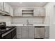 Updated kitchen boasts stainless steel appliances, modern cabinetry, and a stylish backsplash at 554 Mcgill Ne Pl, Atlanta, GA 30312