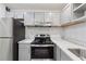 Updated kitchen features modern cabinets, stainless steel appliances, and decorative backsplash at 554 Mcgill Ne Pl, Atlanta, GA 30312