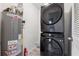 A laundry room with stacked washer and dryer, and water heater at 554 Mcgill Ne Pl, Atlanta, GA 30312