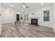 Open living room featuring fireplace, hardwood floors, a ceiling fan, and sliding glass door to the exterior at 554 Mcgill Ne Pl, Atlanta, GA 30312
