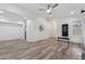 Bright living room features hardwood floors, a ceiling fan, and an open floor plan into the kitchen at 554 Mcgill Ne Pl, Atlanta, GA 30312