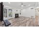 Spacious living area featuring a fireplace, ceiling fan, hardwood floors, and glass doors to the outside at 554 Mcgill Ne Pl, Atlanta, GA 30312