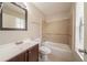 Neutral bathroom with tiled shower-tub combo, and a brown vanity with a white sink at 5175 Walker Rd, Stone Mountain, GA 30088