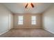 Bedroom featuring two windows, carpet flooring and closet at 5175 Walker Rd, Stone Mountain, GA 30088