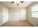 Carpeted bedroom with two doors and a window at 5175 Walker Rd, Stone Mountain, GA 30088