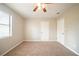 Carpeted bedroom with two doors and a window, offering plenty of space at 5175 Walker Rd, Stone Mountain, GA 30088