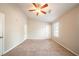 Large bedroom featuring carpet flooring, a ceiling fan, and two closets at 5175 Walker Rd, Stone Mountain, GA 30088