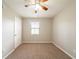 Bedroom with carpet, a window, and a ceiling fan, creating a cozy atmosphere at 5175 Walker Rd, Stone Mountain, GA 30088