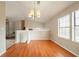 Dining room boasts hardwood floors, a chandelier, and natural light at 5175 Walker Rd, Stone Mountain, GA 30088