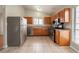 Well-lit kitchen featuring stainless steel appliances, tile floors, and ample cabinet space at 5175 Walker Rd, Stone Mountain, GA 30088