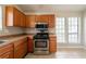 Spacious kitchen with stainless steel oven/microwave and wood cabinetry at 5175 Walker Rd, Stone Mountain, GA 30088