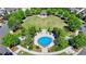 An aerial view of a common area with a blue splash pad, benches, and mature trees at 6585 Creekview Cir, Duluth, GA 30097