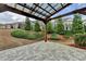 Backyard view showcasing the hardscaped patio, landscaping, and dark metal fence at 6585 Creekview Cir, Duluth, GA 30097